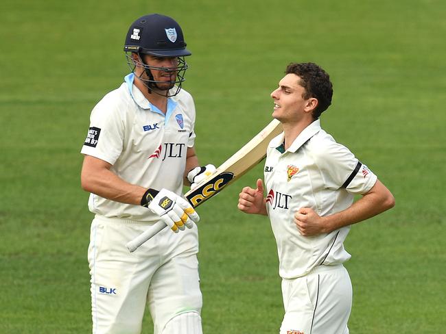 New South Wales batsman Moises Henriques, left, departs after his dismissal at the hands of Simon Milenko. Picture: AAP/Dave Hunt