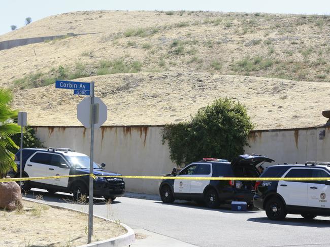 Los Angeles Police patrol the entrance of singer Chris Brown’s street. Picture: AP Photo/Damian Dovarganes