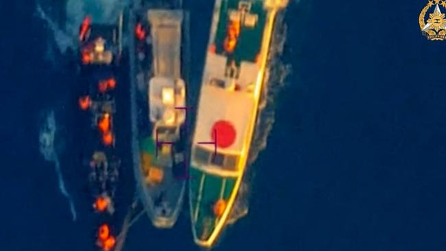 This frame grab from handout video taken on June 17 shows an aerial view of a Philippine Rigid Hull Inflatable Boat (centre) between two China coast guard vessels during an incident off Second Thomas Shoal in the South China Sea. Picture: Armed Forces of the Philippines Public Affairs Office/AFP