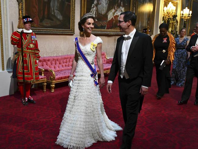 The Duchess of Cambridge and United States Secretary of the Treasury, Steven Mnuchin arrive through the East Gallery ahead of the State Banquet at Buckingham Palace. Picture: AP