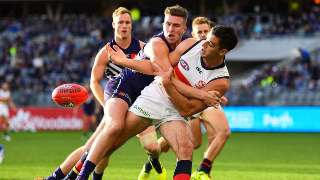 Taylor Walker of the Crows is tackled by Luke Ryan of the Dockers in round 12 last year. Picture: AFL Media/Getty Images