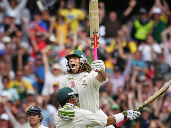 Andrew Symonds celebrates his first Test century with teammate Matthew Hayden.