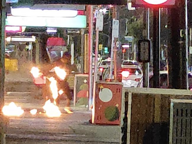 Screen grabs of three men setting fire to the Lux night club in Chapel Street South Yarra.