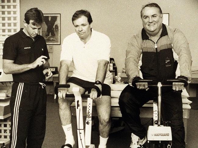 Gary Balkin (right) hits the exercise bike at Sportscare in 1993.