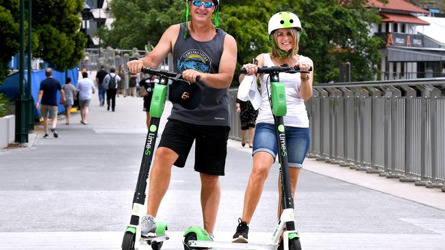 Mark and Liz Ellis from Melbourne ride Brisbane’s Lime scooters.