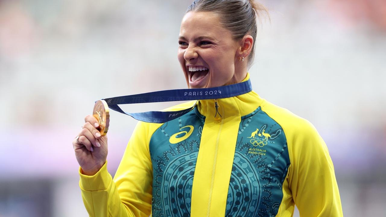 Nina Kennedy brandishing her medal on the podium at the 2024 Olympics in France. Picture: Elsa/Getty Images