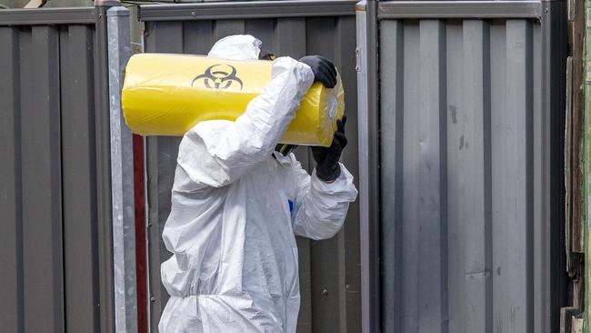 A worker removing materials from the facility on Sunday. Picture: Tim Carrafa