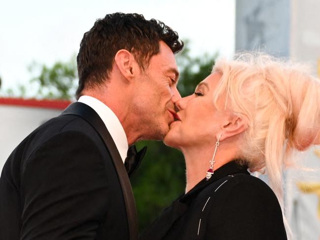 Australian actor Hugh Jackman and his wife Australian director Deborra-Lee Furness kiss as they arrive on September 7, 2022 for the screening of the film 