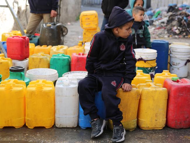 Palestinian children collect water at Zaytoun neighbourhood in Gaza City. Picture: AFP