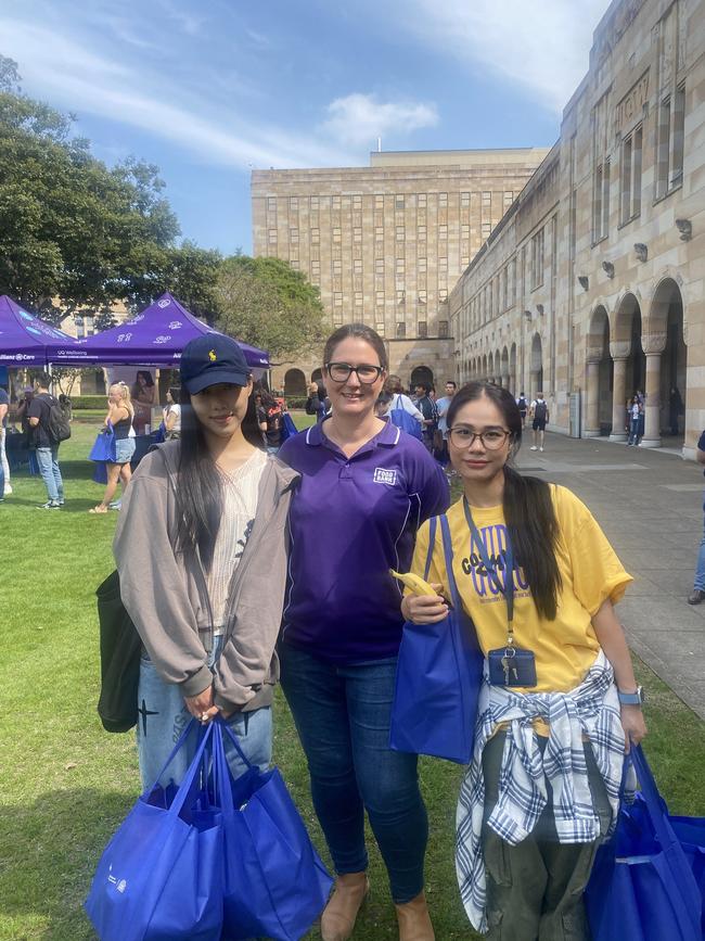 Foodbank Queensland CEO Jess Watkinson with UQ students Xiao Zhang and Yexian Yang from China. Photo: Rose Innes