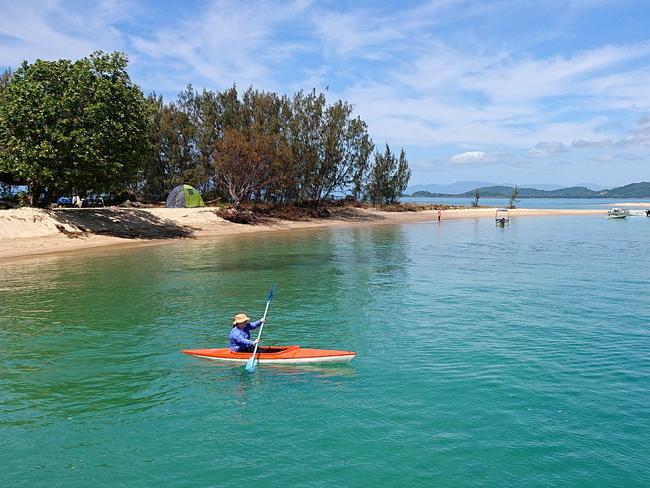 A kayaker paddles in the clear waters off Dunk Island . Dunk Island resort which  has been closed since it was  battered by cylone Yasi and cyclone Larry  Larry . PICTURE: ANNA ROGERS