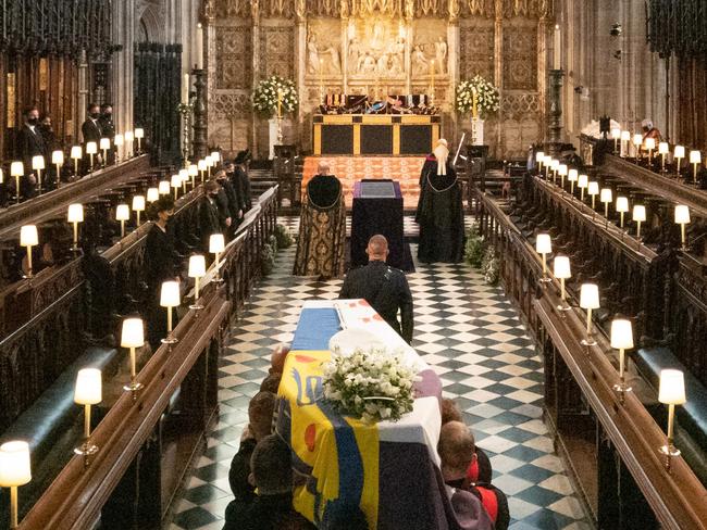 The coffin is carried into The Quire during the funeral service of Britain's Prince Philip, Duke of Edinburgh at St George's Chapel at Windsor Castle, Windsor, west of London, on April 17, 2021. - Philip, who was married to Queen Elizabeth II for 73 years, died on April 9 aged 99 just weeks after a month-long stay in hospital for treatment to a heart condition and an infection. (Photo by Barnaby Fowler / POOL / AFP)