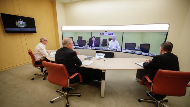 Secretary of the Department of Prime Minister and Cabinet Phil Gaetjens, Scott Morrison and Chief Medical Officer Professor Brendan Murphy speak with Gladys Berejiklian. Picture: Getty Images