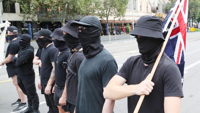 The masked men, dressed in black, who taunted transgender right activists protesting against “Let Women Speak” before performing the Nazi salute on the steps of Victorian Parliament on March 8. Picture: NCA NewsWire / David Crosling