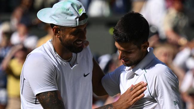 Australia's Nick Kyrgios (L) congratulates Serbia's Novak Djokovic for his victory during their men's singles final tennis match on the fourteenth day of the 2022 Wimbledon Championships at The All England Tennis Club in Wimbledon, southwest London, on July 10, 2022. (Photo by SEBASTIEN BOZON / AFP) / RESTRICTED TO EDITORIAL USE