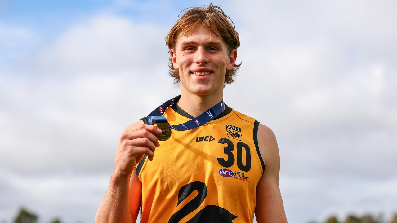 MELBOURNE, AUSTRALIA - JULY 09: Daniel Curtin of Western Australia poses with the Western Australia MVP award following the 2023 AFL National Championships match between Vic Metro and Western Australia at RSEA Park on July 09, 2023 in Melbourne, Australia. (Photo by Graham Denholm/AFL Photos via Getty Images)