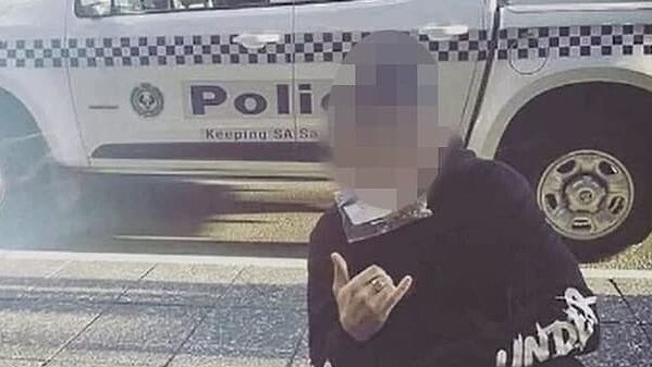 An eshay posing in front of an SA Police wagon.