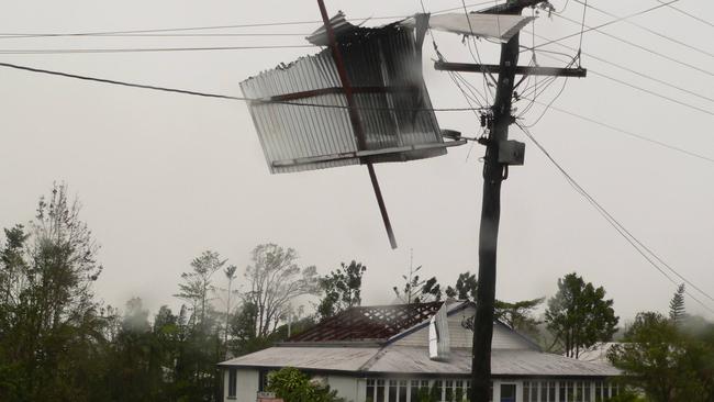 MARCH 2006: Part of a roof hangs high up in power lines in Millaa Millaa after cyclone Larry. Picture: John Andersen. SUPPLIED PIC