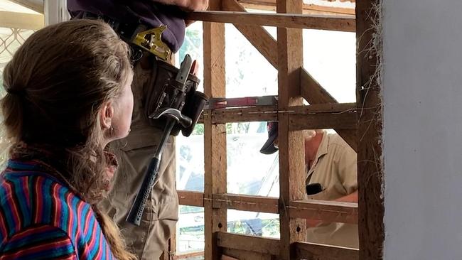 Naomi Shine, lead builder for Lismore‘s Two Rooms project, supervises the removal of flood impacted wall boards in a Lismore home. Picture: Cath Piltz