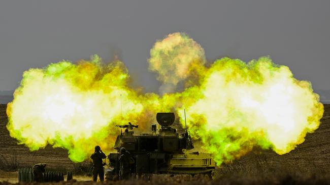 An IDF Artillery soldier covers his ears as a shell is fired towards Gaza, near Netivot, Israel. Picture: Getty