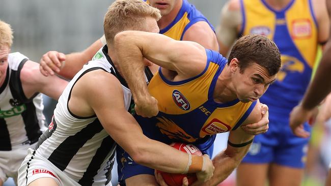 Jamie Cripps tries to bust free from an Adam Treloar tackle on Sunday. Picture: Paul Kane/Getty Images