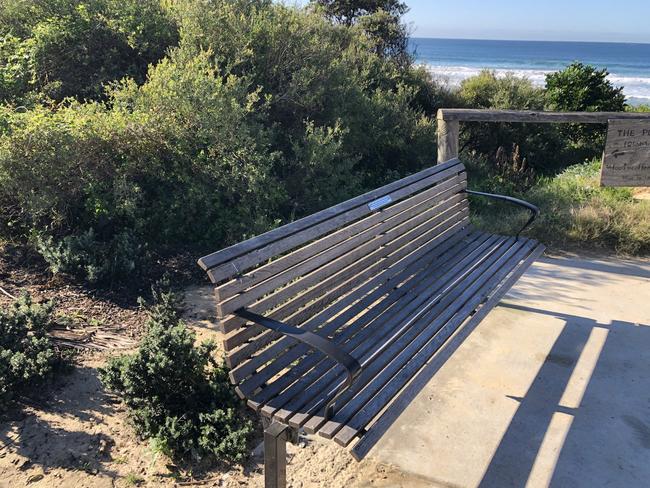 A seat, with a memorial plaque attached, at Freshwater Beach. Picture: Jim O’Rourke