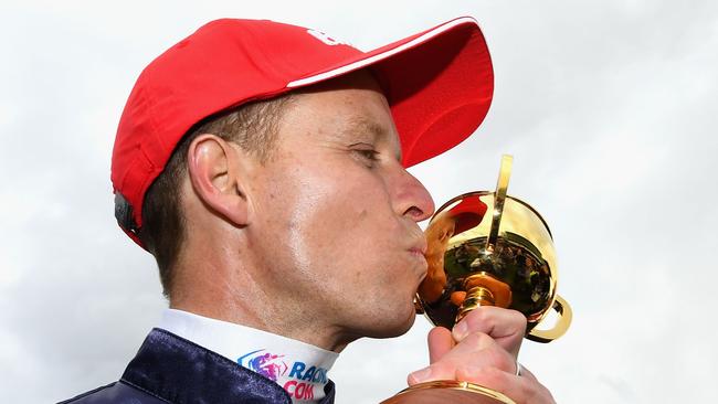 Kerrin McEvoy kisses the Melbourne Cup after his second win in the race aboard  Almandin in 2016. Picture: Quinn Rooney/Getty Images