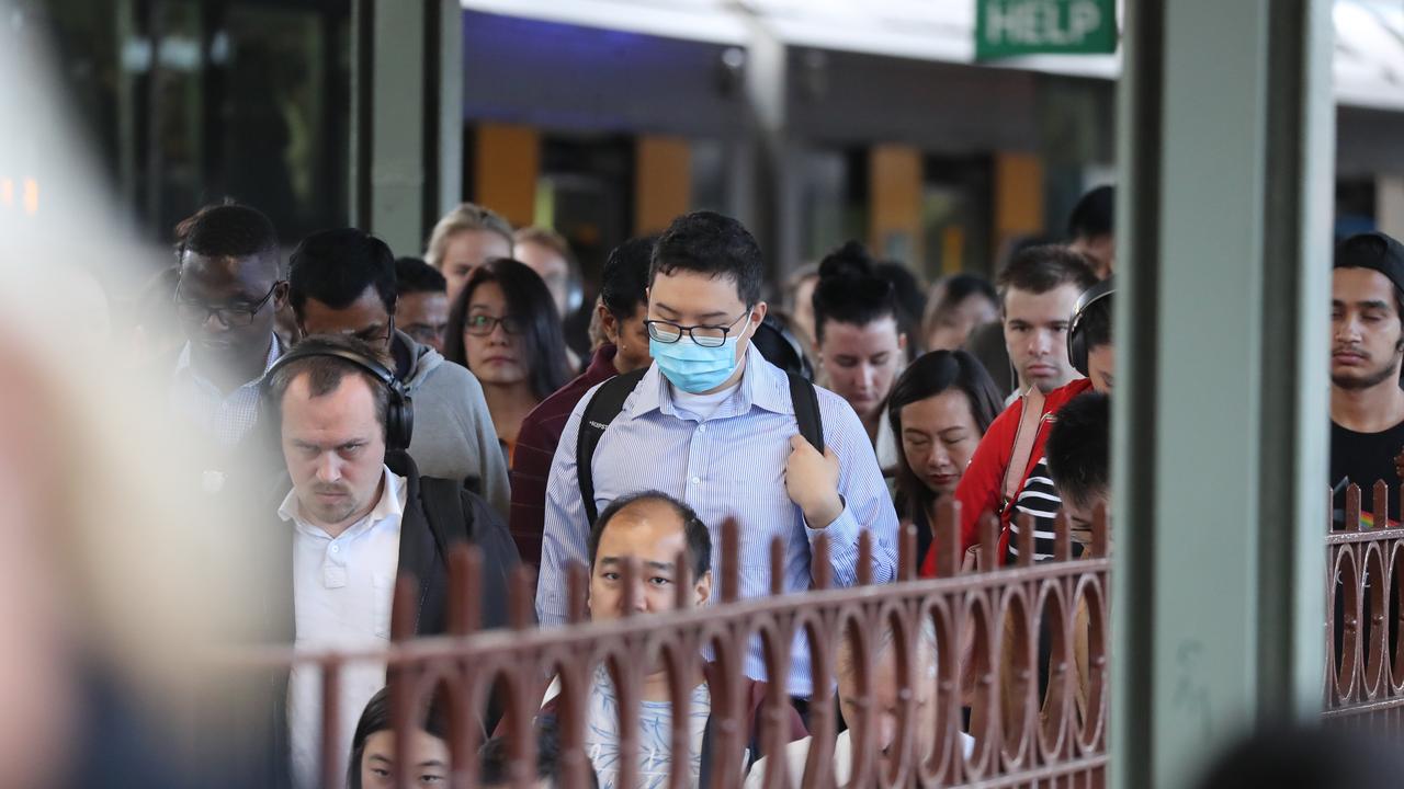 Commuters at Sydney’s Central Station wearing face masks. Picture: Rohan Kelly