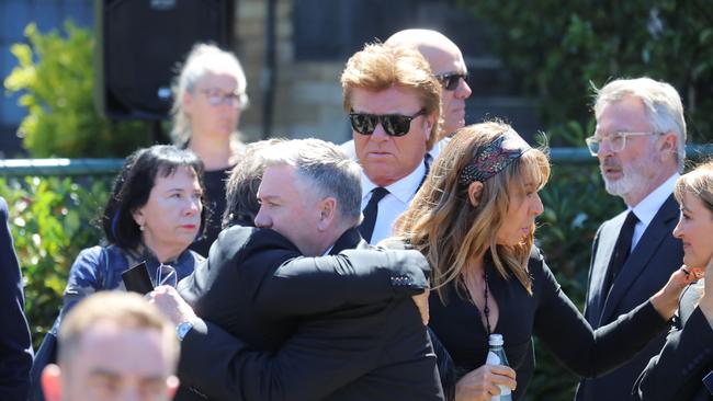 Jon Stevens and Eddie Maguire hug after the service. Picture: Alex Coppel.