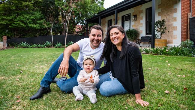 Alex and Rachel with baby Eva, 1, in front of the home they recently bought at auction in Hawthorn. Picture: Tom Huntley