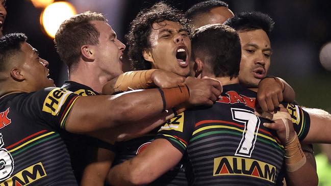 Nathan Cleary (No.7) celebrates with teammates after scoring one of his three tries against the Roosters at Panthers Stadium.