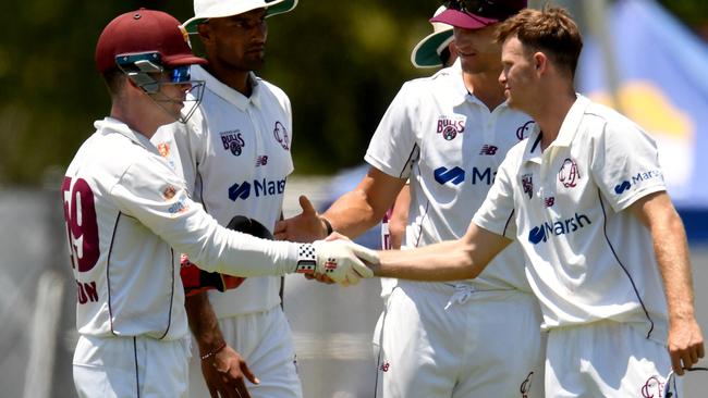 Queensland keeper Jimmy Pierson congratulates spinner Matthew Kuhnemann Picture: Evan Morgan