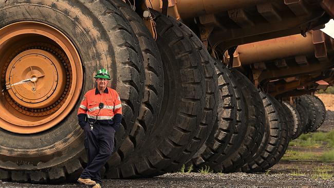 New Acland pit operator Stewart Mills with dump truck number 310 – the truck he learnt to drive in. The truck is among dozens of machines sitting idle while the next stage of the Oakey mine awaits approval. Picture: Lyndon Mechielsen