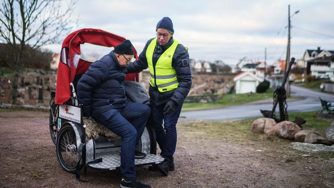 Morgan Simonsson cycles with his stepdad Ingvar Kristiansson on a ride they take once a week to help break Ingvar's isolation during the pandemic. Picture: Getty Images.