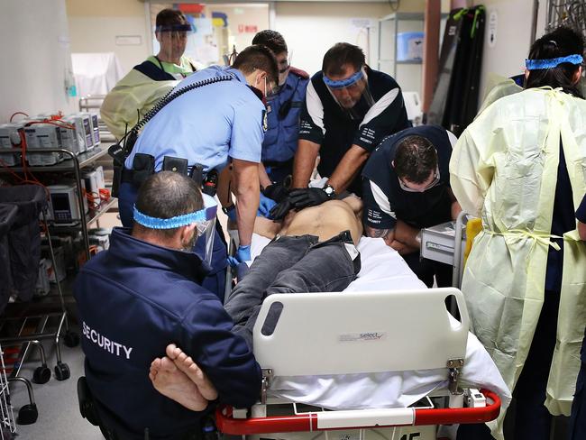 *****EMBARGOED PICTURES HOLD FOR PAUL TOOHEY STORY******Ice Project 2015 Ice Project Royal Perth Hospital. GR1108201501. The Royal Perth Hospital Emergency Department. A young indigenous man is brought to the Emergency Department at Royal Perth in a state of psychosis and is treated by the emergency medical staff.Pic by Gary Ramage