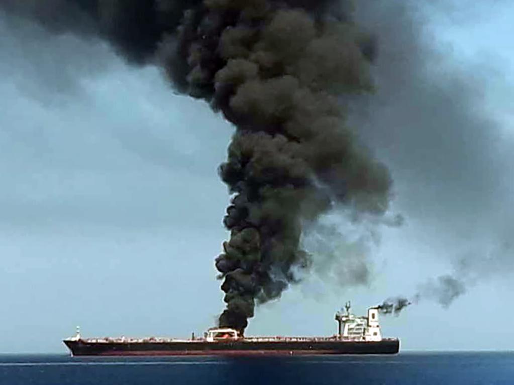 Smoke billows from a tanker said to have been attacked off the coast of Oman. Such attacks have increased tensions between Iran and the US. Picture: AFP