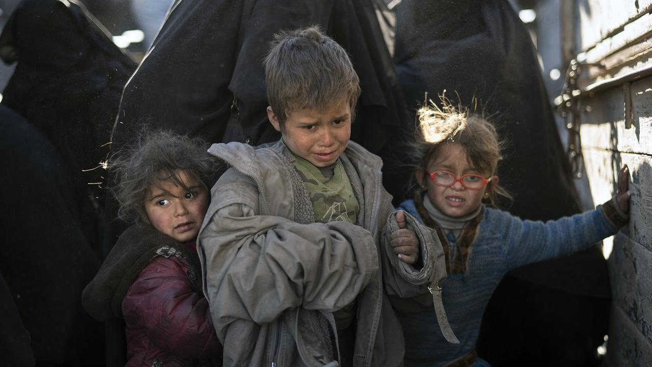 Women and children are being evacuated out of the last territory held by Islamic State militants, in the desert outside Baghouz, Syria. Picture: AP Photo/Felipe Dana