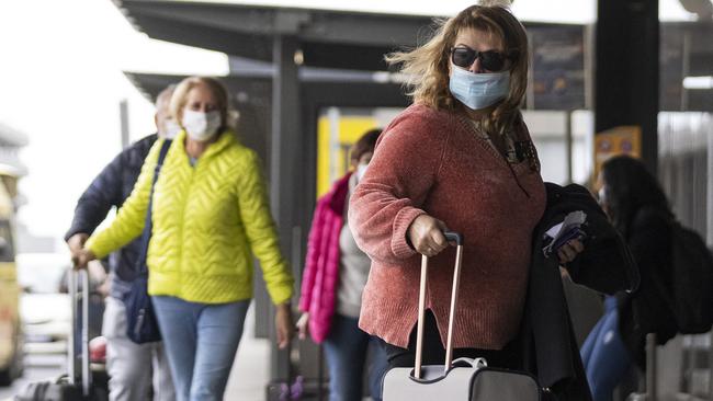 People enter the Virgin Australia domestic departures terminal in Melbourne on Thursday after the airline cancelled more than 10 flights. Picture: Getty Images