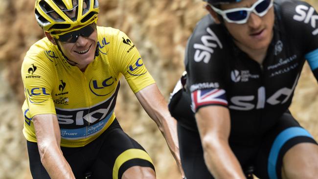 Great Britain's Christopher Froome (L), wearing the overall leader's yellow jersey rides behind Great Britain's Geraint Thomas rides in the pack during the 178,5 km fourteenth stage of the 102nd edition of the Tour de France cycling race on July 18, 2015, between Rodez and Mende, southern France. AFP PHOTO / JEFF PACHOUD