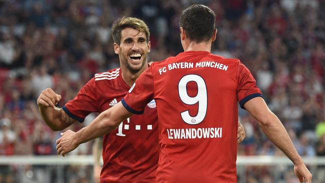 Bayern Munich's Spanish midfielder Javi Martinez (L) and Polish forward Robert Lewandowski (R) celebrate after their team's first goal.