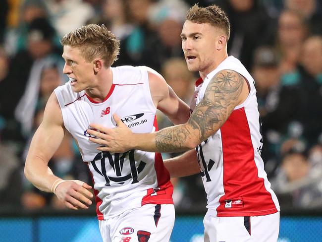 Sam Frost of the Demons is congratulated by team mate Dean Kent.