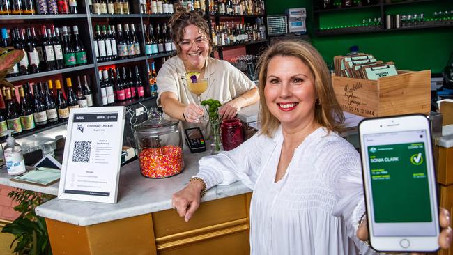 Sonia Clark with Zoe Gelman-Malan, assistant manager at Daughter in Law – an Adelaide bar that offered a free drink to people who are vaccinated and can prove it. Picture: Tom Huntley