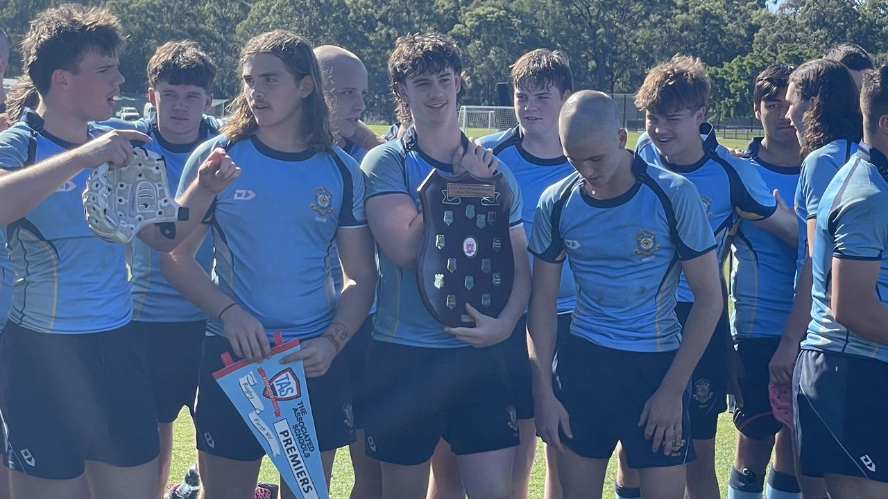 The St Columban's First XV celebrating the grand final win. Gun scrumhalf Phoenix is fourth from the left facing downwards.