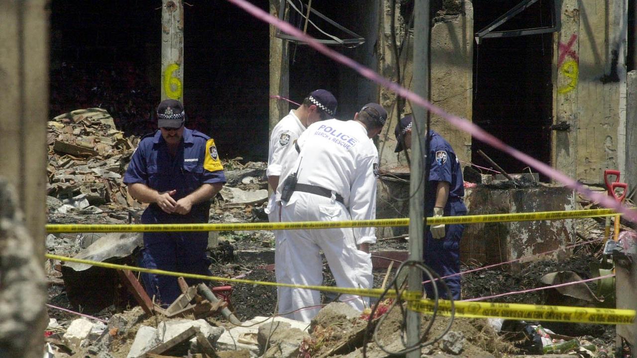 October 21, 2002. Australian police officers pick through the ruins of the Sari Club, where a terrorist bombing attack killed more than 180 people and injured 300. Photo: AP Photo/Achmad Ibrahim.