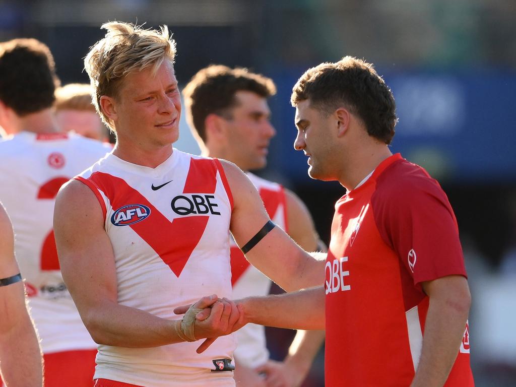 Isaac Heeney and Tom Papley after their loss on Sunday, with Papley seriously injuring his ankle. Picture: Matt Roberts/AFL Photos/via Getty Images.