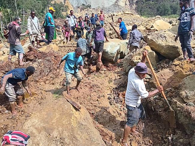 People digging at the site of a landslide at Yambali Village in the region of Maip Mulitaka, in Papua New Guinea's Enga Province.