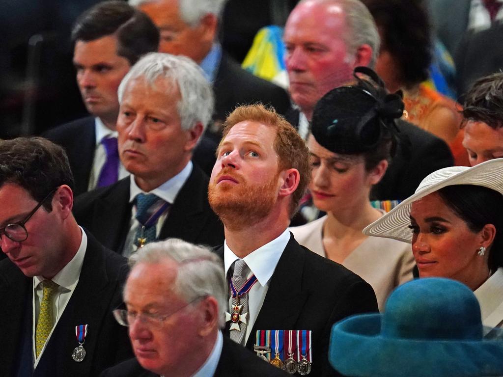 Prince Harry looks up at the ceiling and Meghan Markle looks ahead during the service. Picture: Getty Images