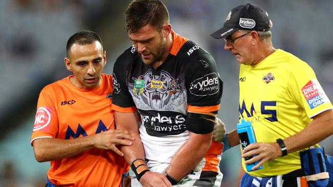 Tim Grant is helped from the field after sustaining an injury. Picture: Gregg Porteous