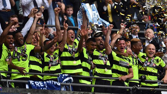 Aaron Mooy (far right) and his Huddersfield Town teammates lift the Championship Playoff trophy. Picture: AFP