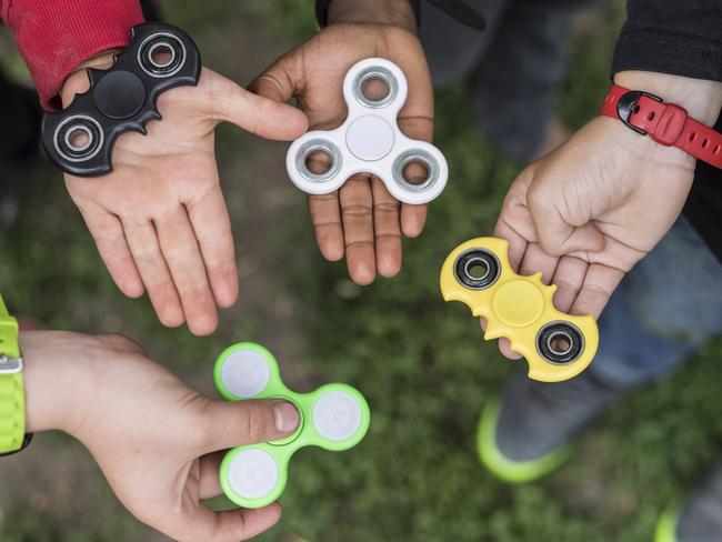 FILE - In this May 18, 2017 file photo children hold fidget spinners at a school in Bern, Switzerland. Frankfurt customs authorities said Friday, June 16, 2017 they confiscated 35 tons of the tiny twirling gadgets in May alone and plan on crushing them out of existence. (Alessandro della Valle/Keystone via AP, file)